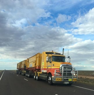 Truck driving down a road