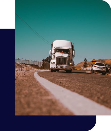 Truck driving down a road